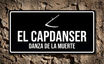 Placa negra sobre muro de piedra con el icono de una guadaña blanca, representando al Capdanser (Maestro de Baile) de la Danza de la Muerte de Verges.