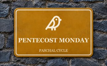 Ochre sign on a slate wall with a pictogram and the words “PENTECOST MONDAY”.