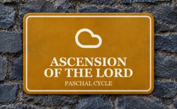 Ochre sign on a slate wall with a pictogram and the words “ASCENSION OF THE LORD”.