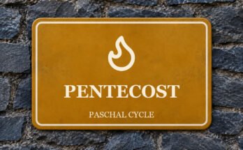 Ochre sign on a slate wall with a pictogram and the words “PENTECOST”.