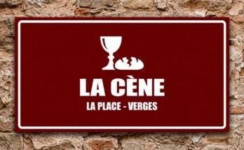 Calice blanc et pain rompu sur un panneau rouge «La Cène · La Place, Verges».