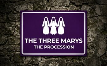 Three women in white cloaks on a purple sign reading “The Three Marys · The Procession”.