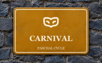 Ochre sign on a slate wall with a pictogram and the words “CARNIVAL”.