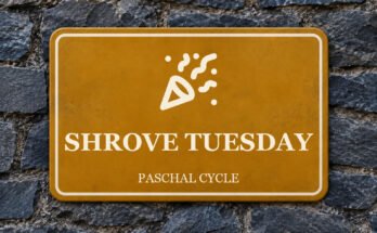 Ochre sign on a slate wall with a pictogram and the words “SHROVE TUESDAY”.
