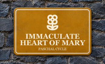 Ochre sign on a slate wall with a pictogram and the words “IMMACULATE HEART OF MARY”.