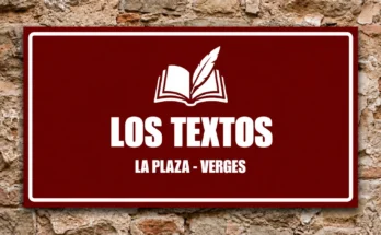 Cartel rojo con un libro y una pluma blancos y el texto «Los textos · La Plaza - Verges», sobre un muro de piedra.